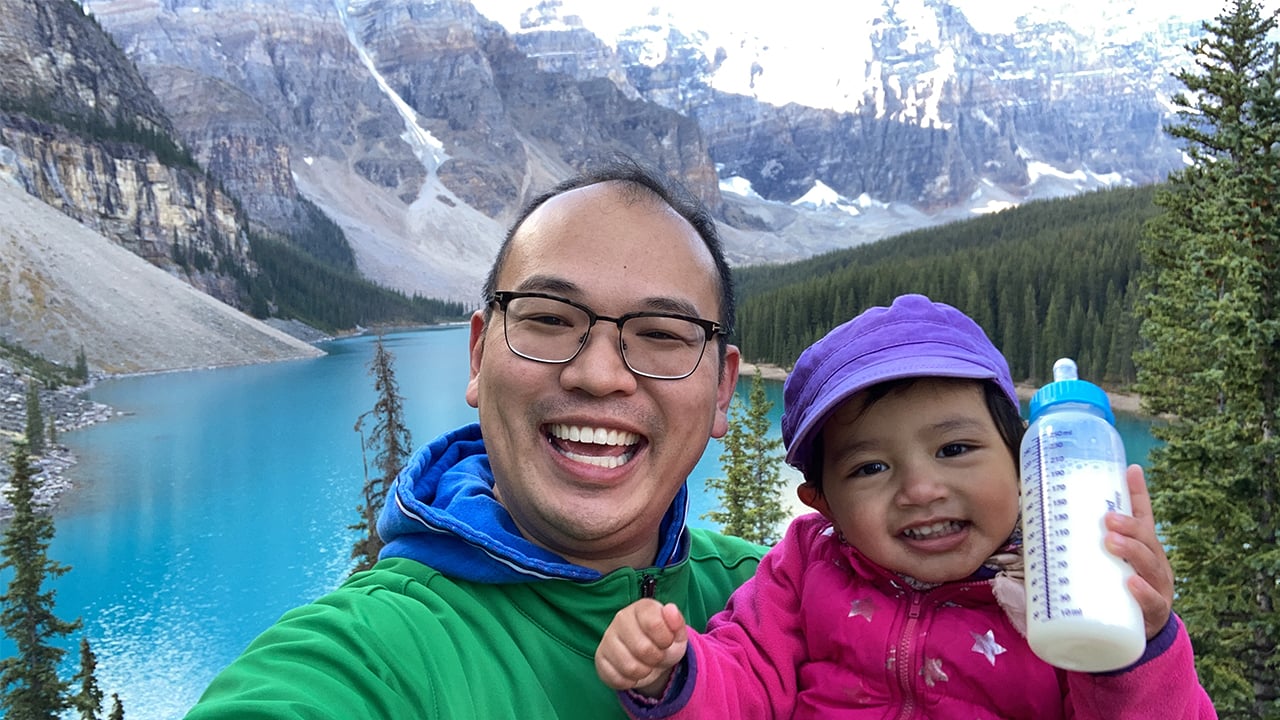 Photo of the author and his daughter posing for a selfie in front of Moraine Lake in Banff National Park