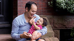 Photo of the author and his daughter sitting on a stoop