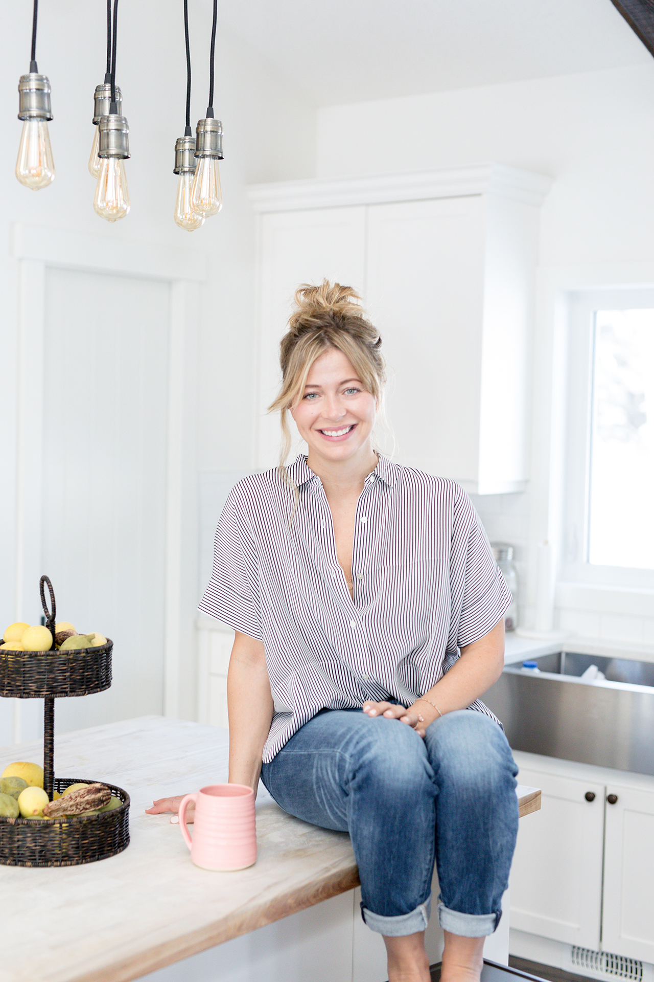 GoCleanGo's Sarah McAllister sits on the counter in her kitchen for a story with 5 cleaning tips