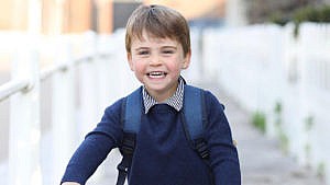 prince louis poses with his backpack for his first day of nursery school