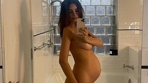 Emily Ratajkowski standing naked in her bathroom showing her baby bump