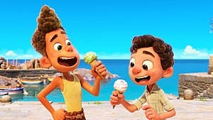 Still from Luca showing two animated kids eating ice cream by the shore