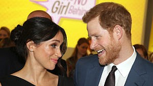 prince harry and meghan markle look playfully at each other
