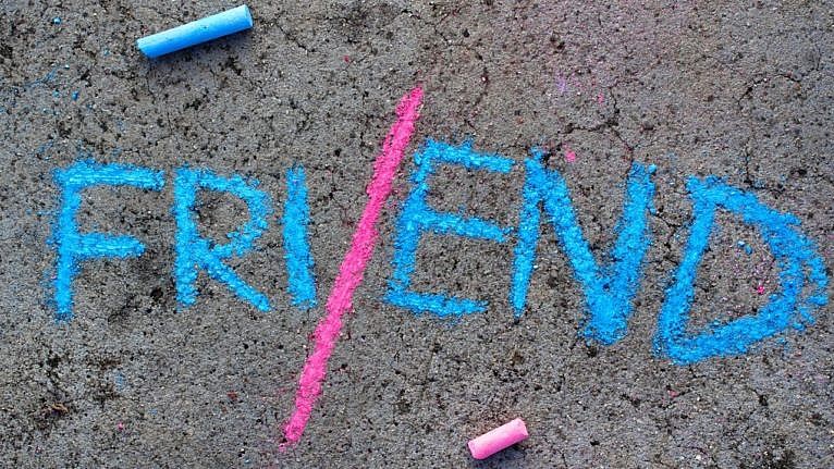 the word friend spelt in blue chalk with a pink line separating FRI and END