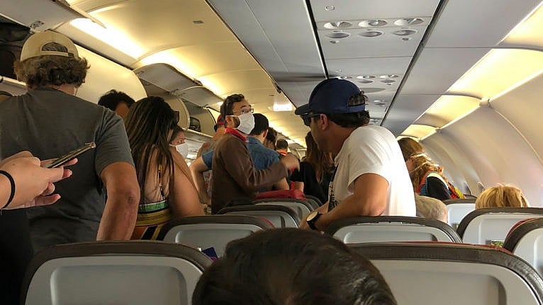 people on a plane arriving at a sunny destination