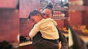 Photo of Chrissy hugging her son Miles