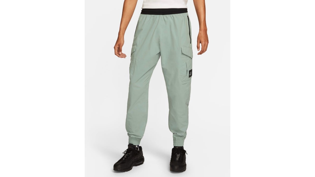 Dusty sage coloured cargo trousers with zipped pockets on the sides