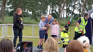 still from a clip of Prince William and his two elder kids, Prince George and Princess Charlotte, kicking off a race.