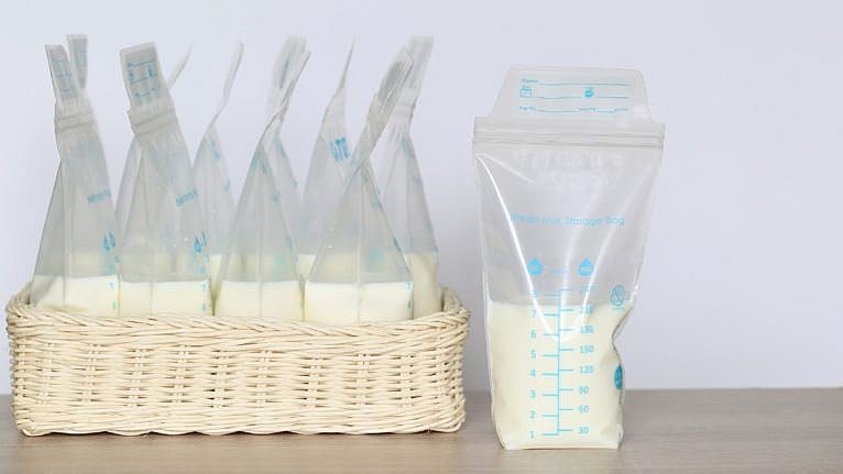 a photo of frozen breast milk storage bags on wooden table
