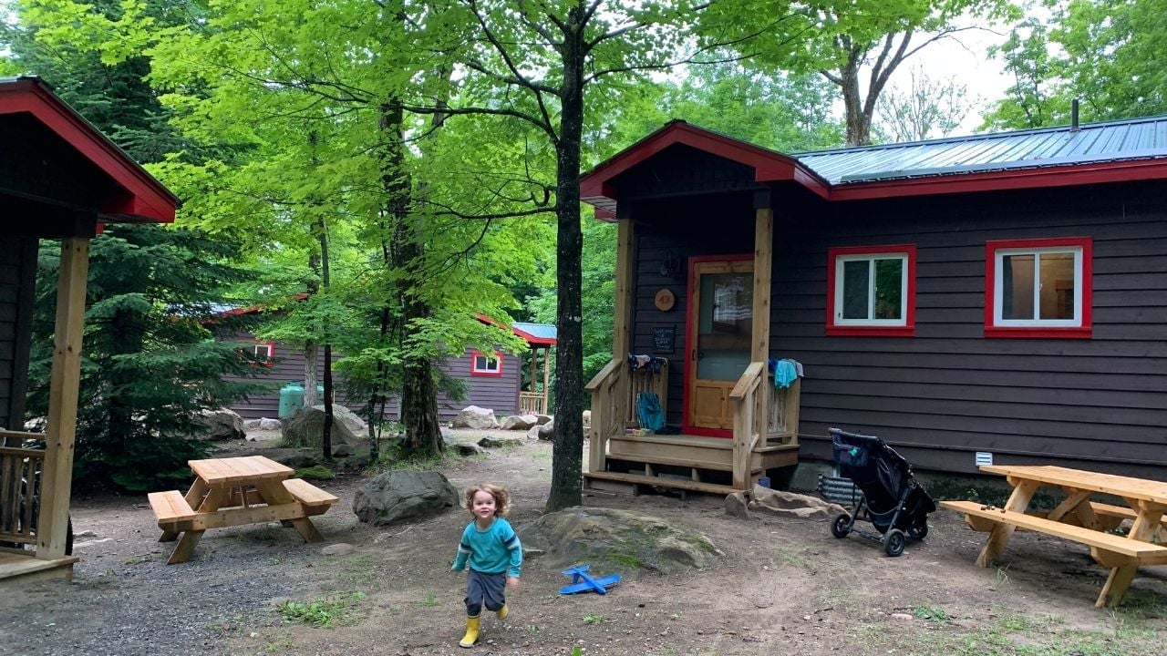 little boy outside cabin