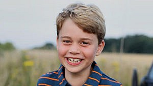 Prince George smiles for the camera outside for his 8th birthday portrait