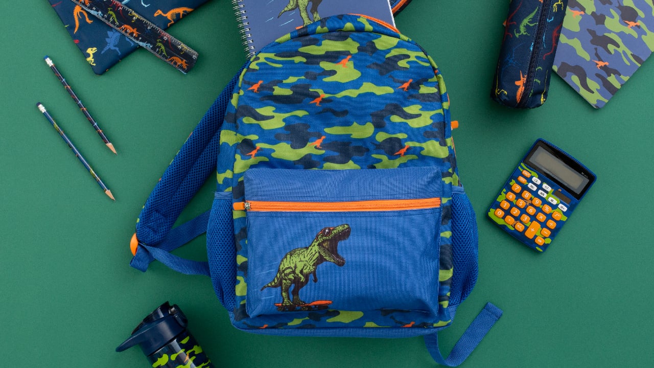 Dark blue backpack with green dinosaur and camo motif