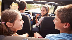 Photo of a family laughing together in a car