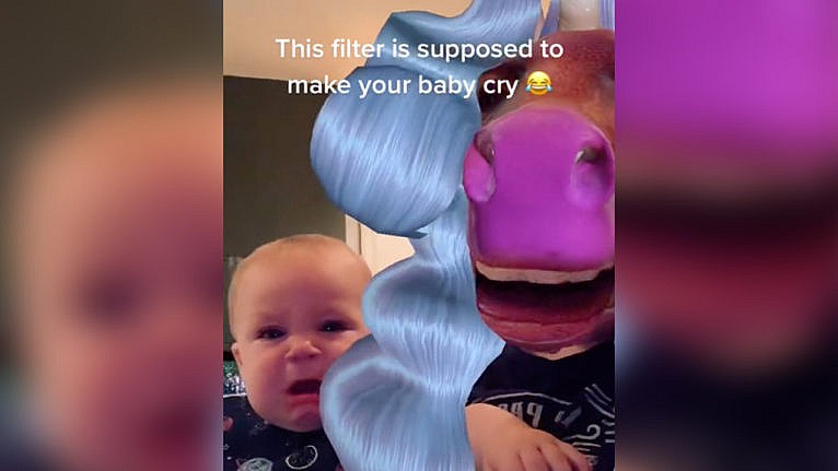 Photo of a terrified baby reactign to a face filter that turns you into a unicorn