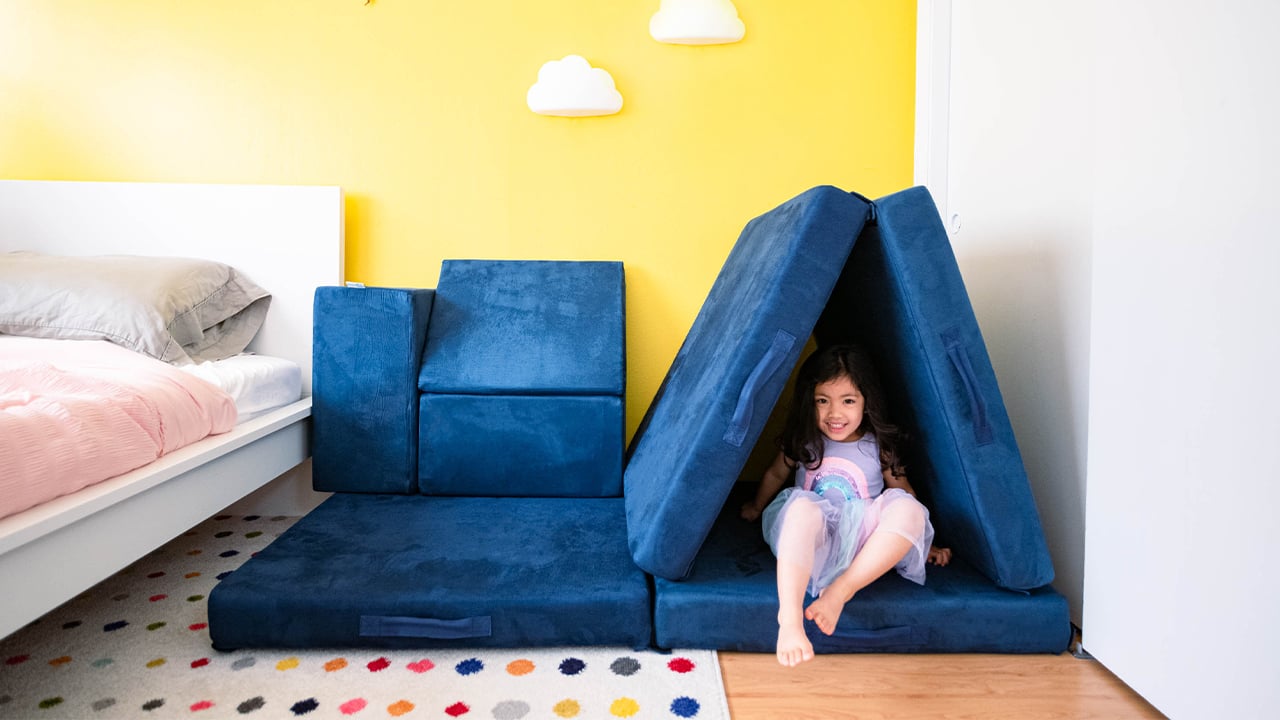 Photo of a kid playing in a tunnel made from a Figgy Play couch