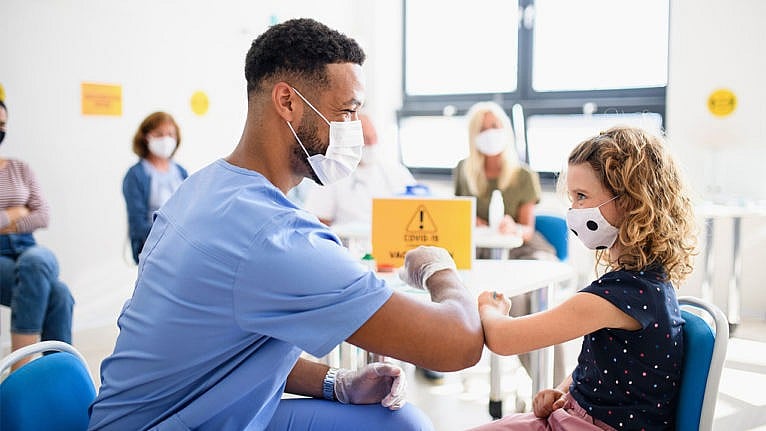 a young girl smiles at a male nurse