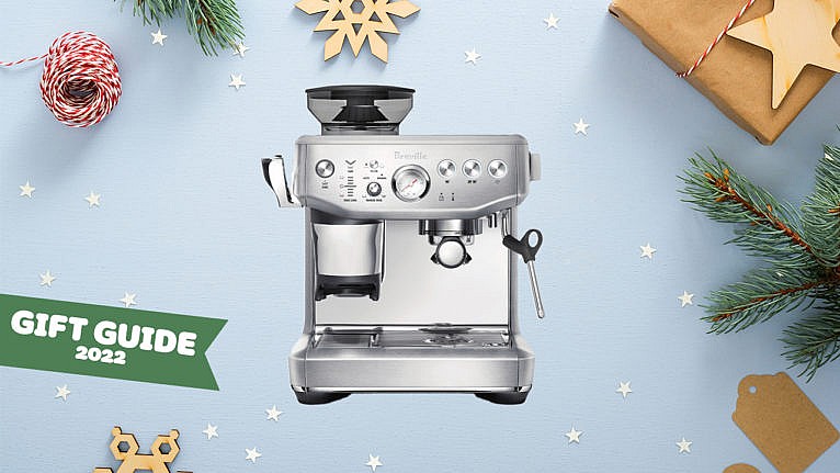 An espresso machine on a holiday-themed background