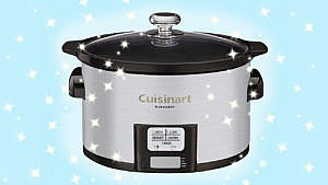 a silver slow cooker in front of a blue background