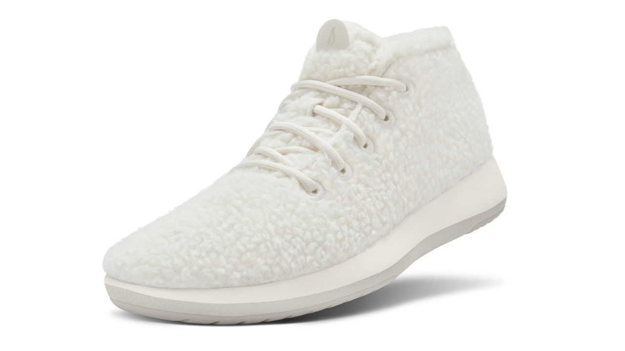 white fluffy water-repellant running shoes with white soles and white laces