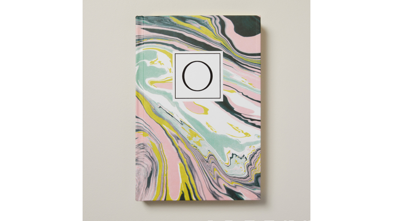 pastel coloured journal with marble design and monogrammed with a letter