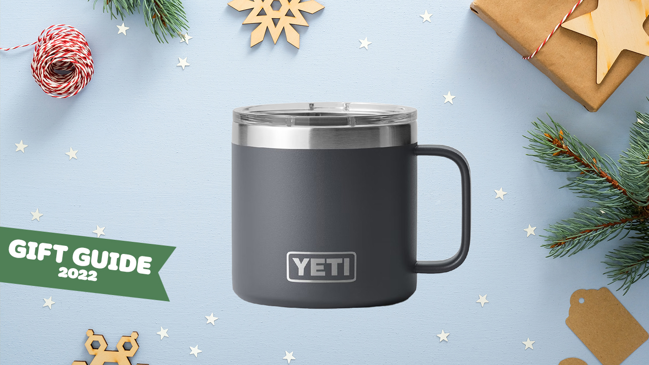 An insulated mug with a lid on a holiday background.