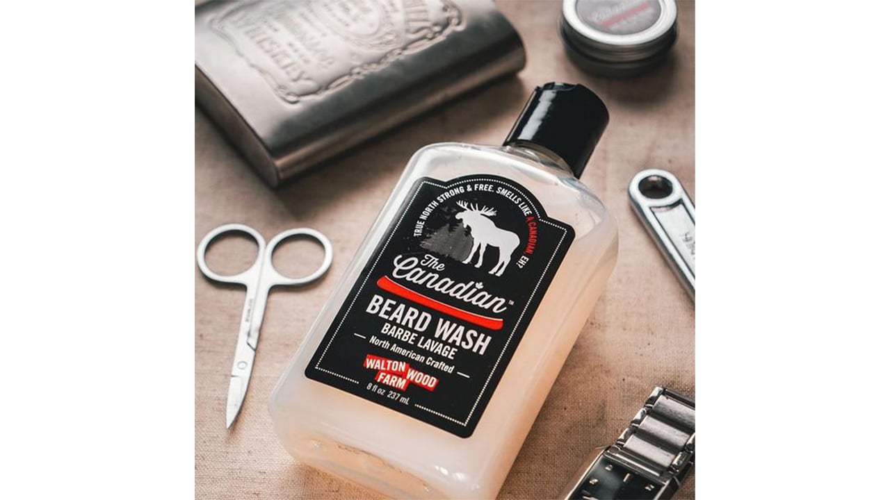 Bottle of beard wash with black label and moose illustration