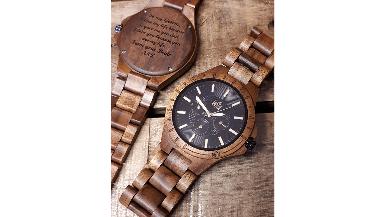 Wooden watch with black face and engraved message on back