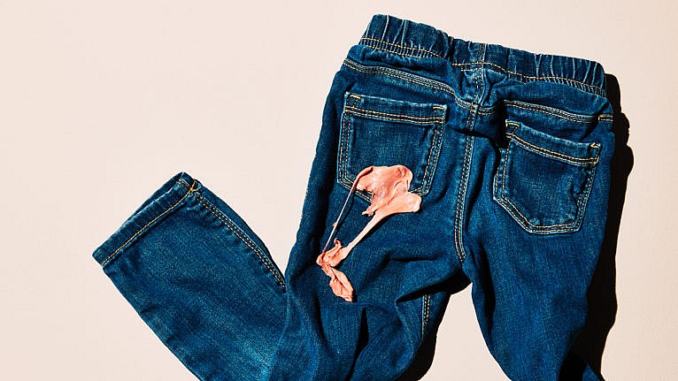 blue jeans with gum stuck on the back pocket