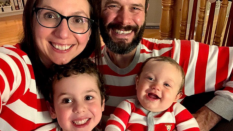 Photo of the author's family of four wearing matching red and white pajamas on christmas morning