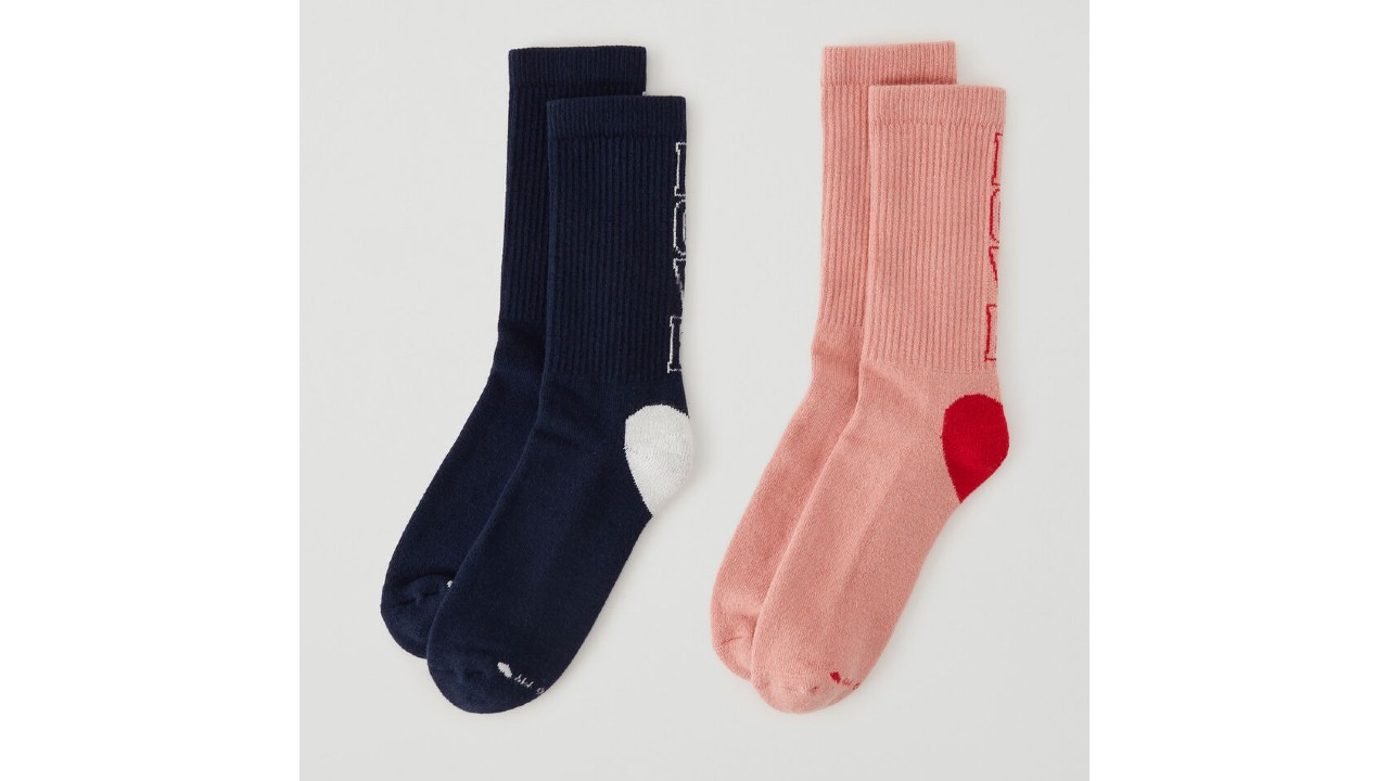 Two pairs of socks, one black and one pink, with LOVE written on the back