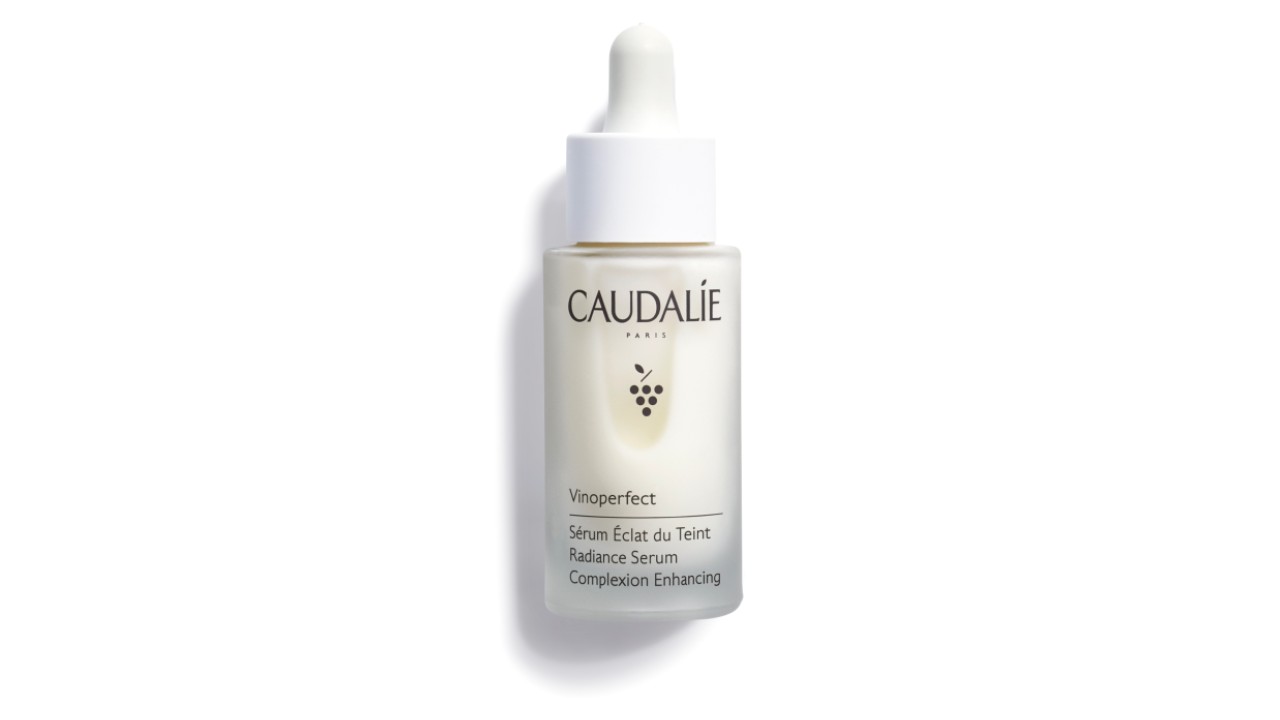 Caudalie serum is in a clear bottle with a dropper. The serum is a milky white.