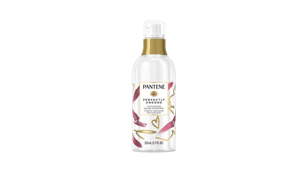 An image of a white Pantene spray bottle with a gold rim at the top.