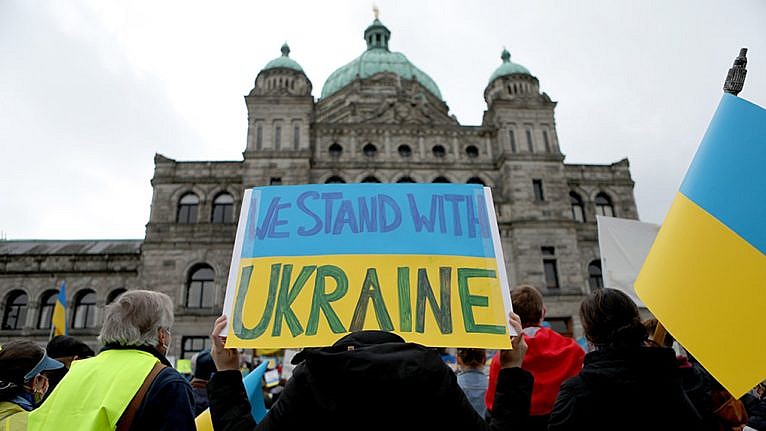 A poster painted like the Ukrainian flag reading 
