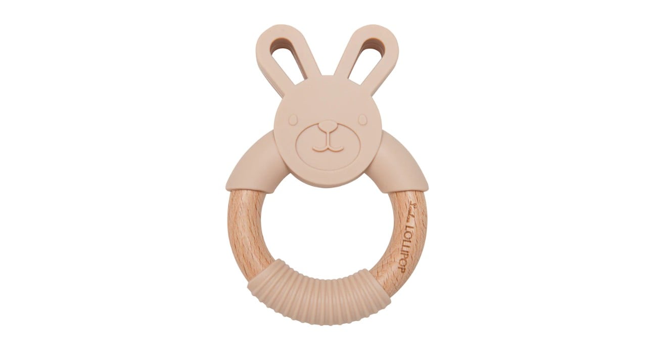 A wooden and brown silicone teether with a bunny on top.
