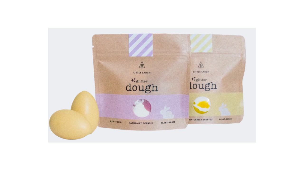 Brown paper bags of pink and yellow moldable dough.