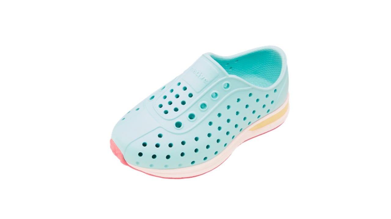 A light blue, pink and white rubber sneaker with holes in it.