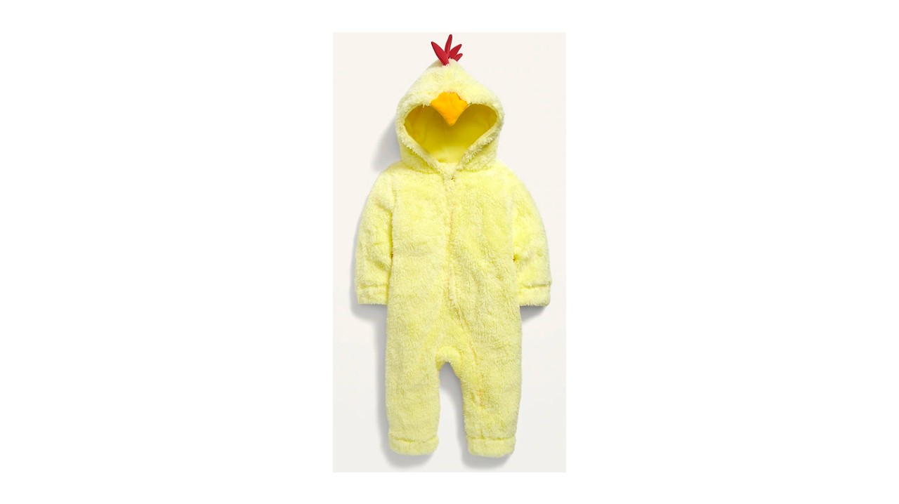 A fuzzy yellow baby onesie with a beak and red hair on the hood.