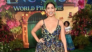 "Encanto" actor Stephanie Beatrice smiles and poses with her hand on her hip while at the Encanto world premiere