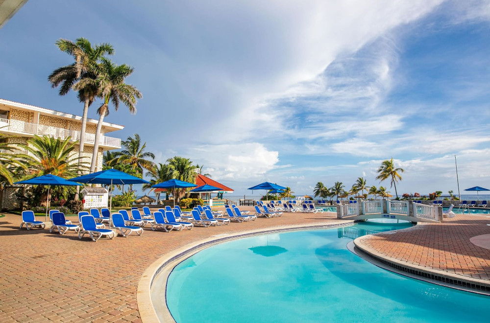 A pool with lounge chairs and a hotel room at Holiday Inn Resort in Montego Bay 