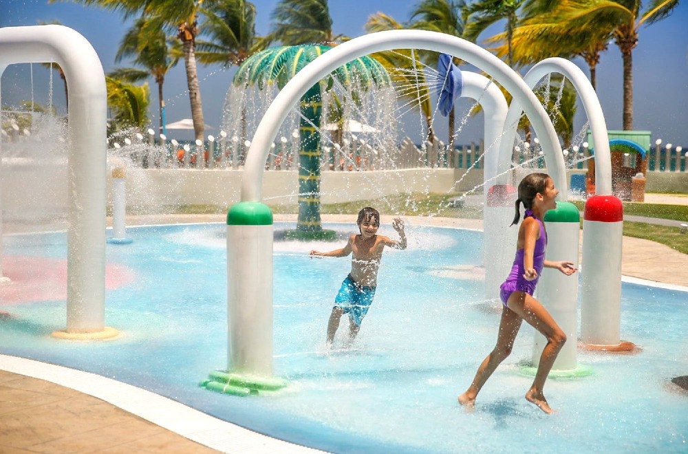 Kids play in a splash pad at the Moon Palace resort in Ochos Rios, Jamaica