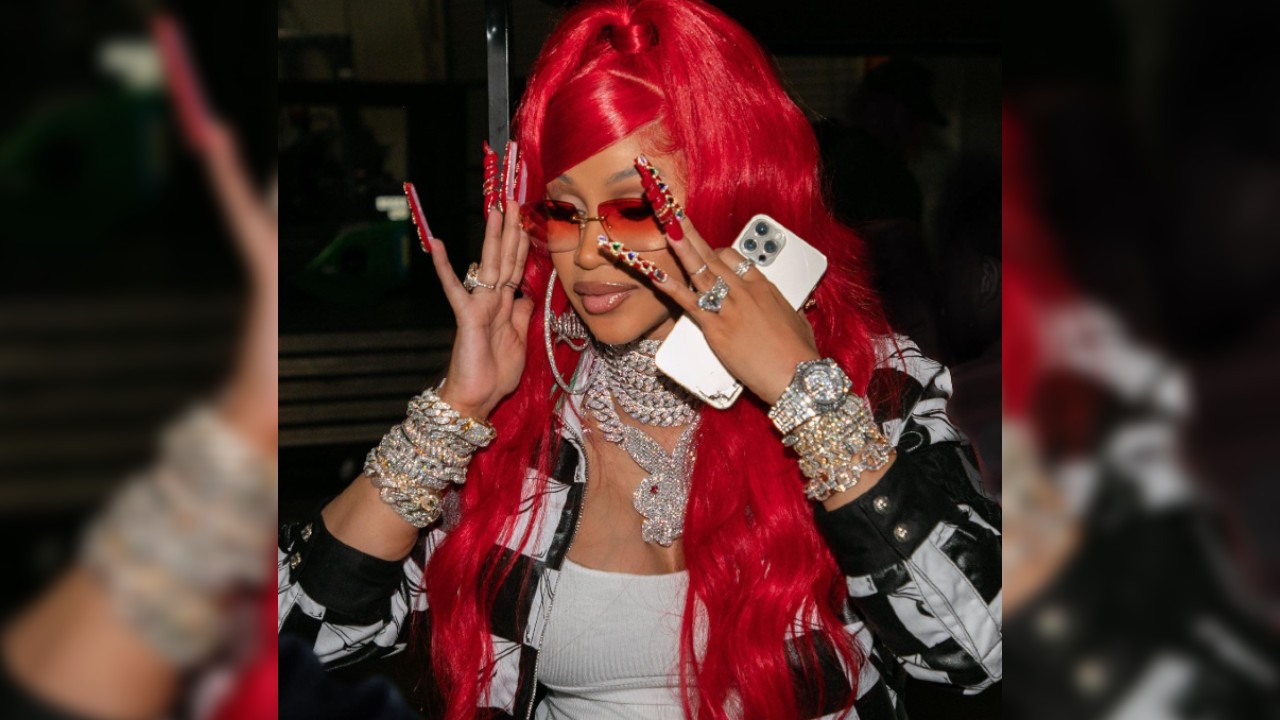 Cardi B wearing long bedazzled red nails