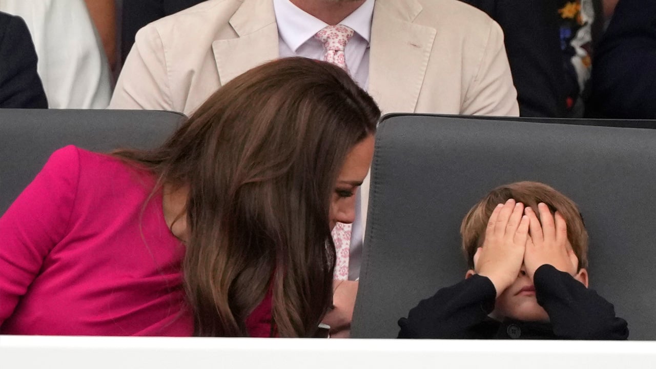 Prince Louis covers his eyes as he talks to mother Kate Middleton during the platinum anniversary pageant