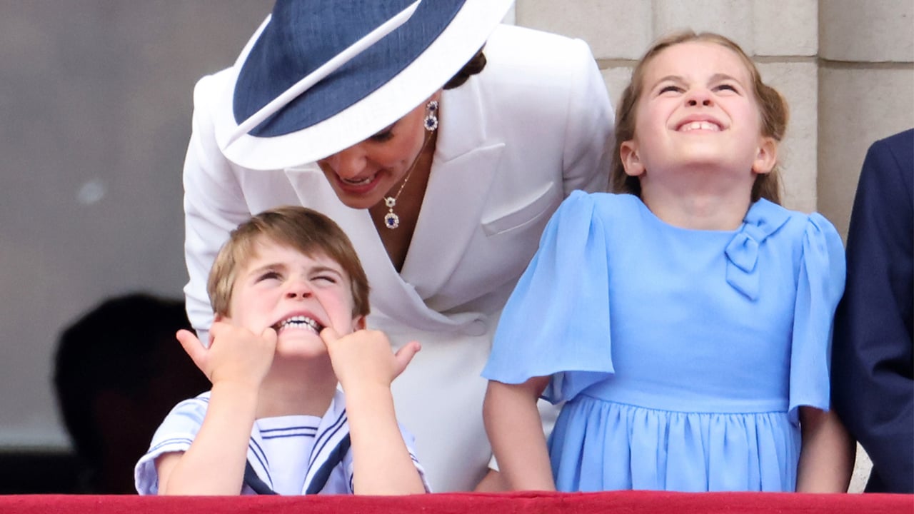 Prince Louis makes a silly face with his fingers in his mouth on the balcony during Trooping the Colour