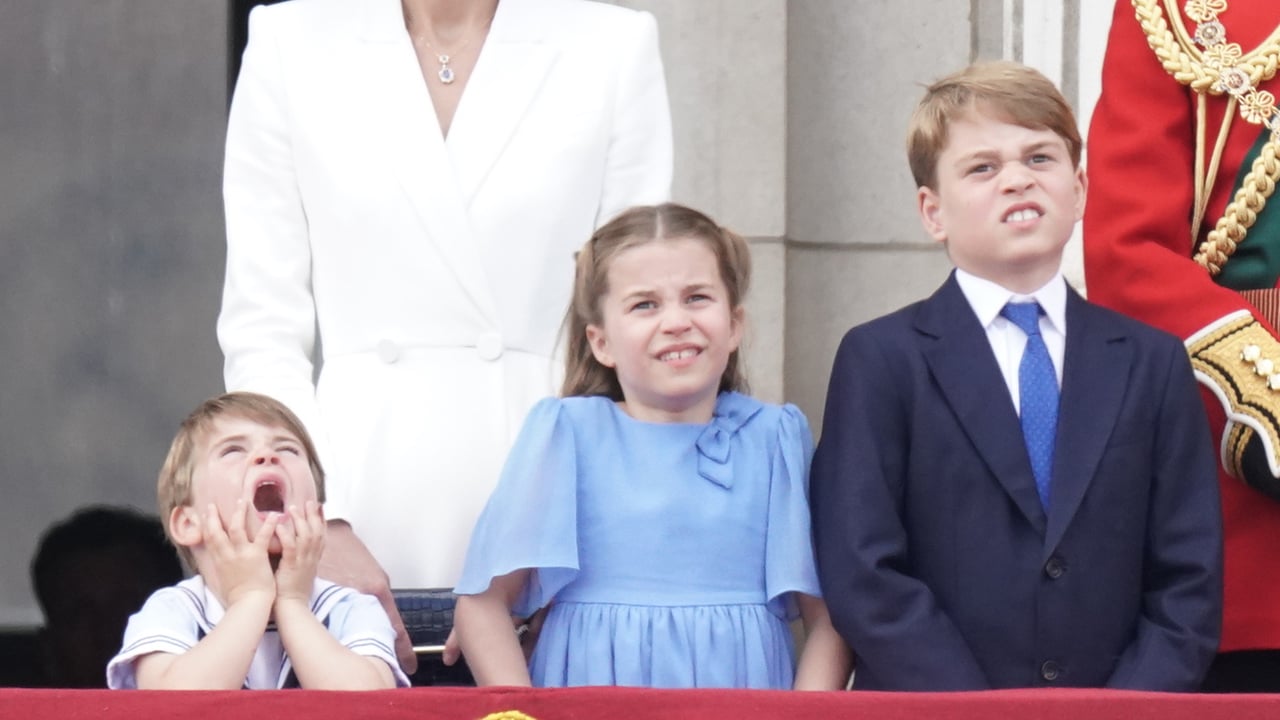 Prince Louis makes a silly face standing next to his sister Charlotte and brother George at Trooping the Colour
