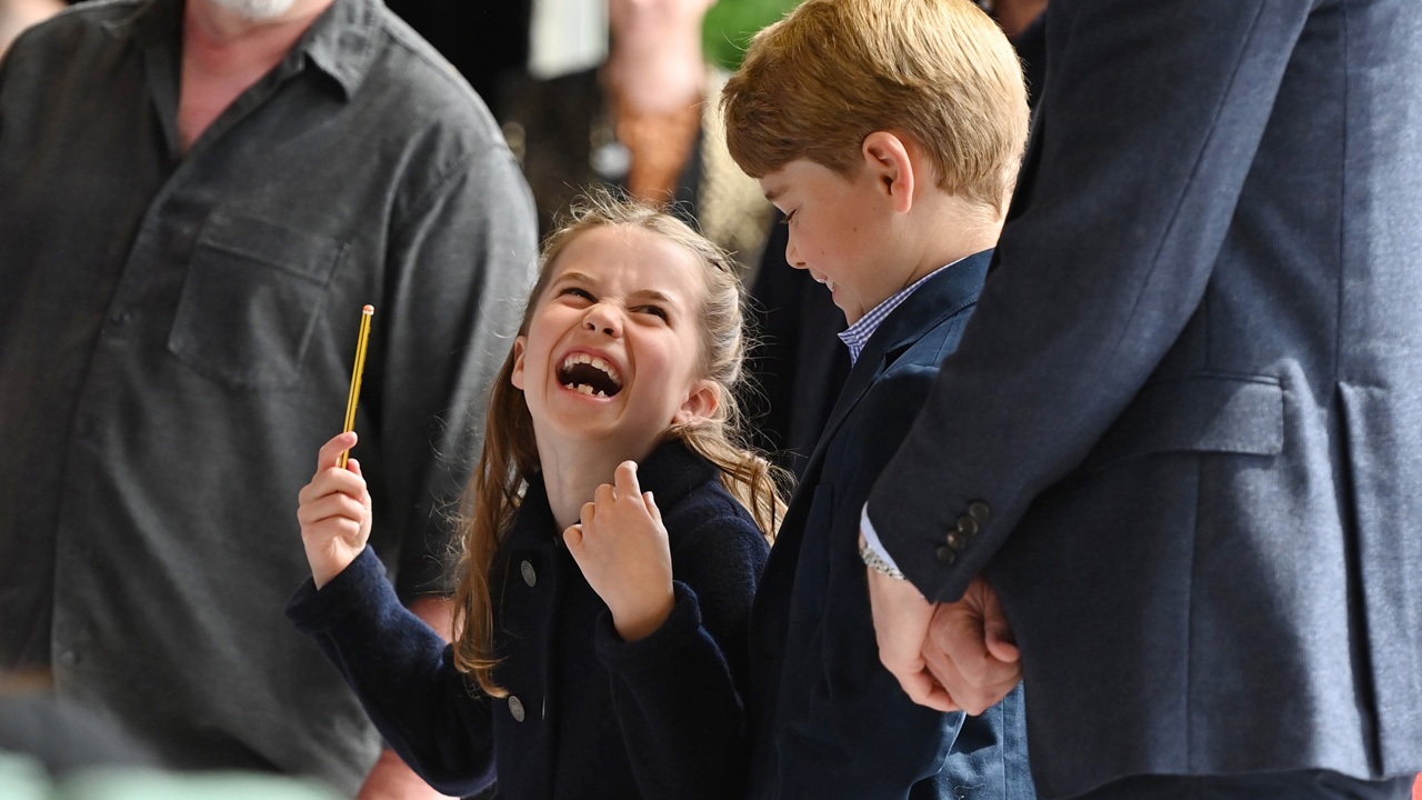 Princess Charlotte giggles beside her brother Prince George while 