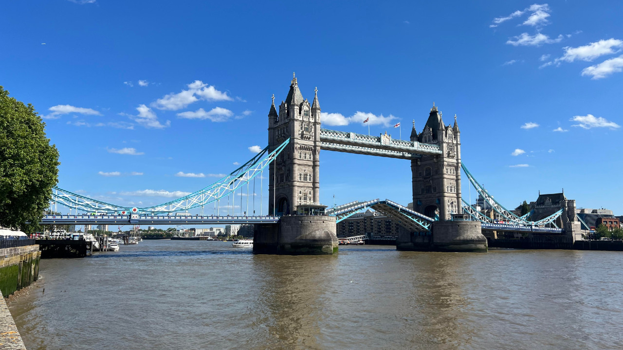 View of the Tower Bridge above the River Thames on a day with a clear blue sky