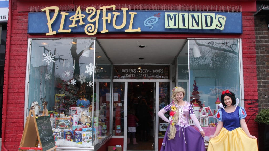 The storefront of Playful Minds, a Toronto toy store on St. Clair Avenue West, with two princesses out front