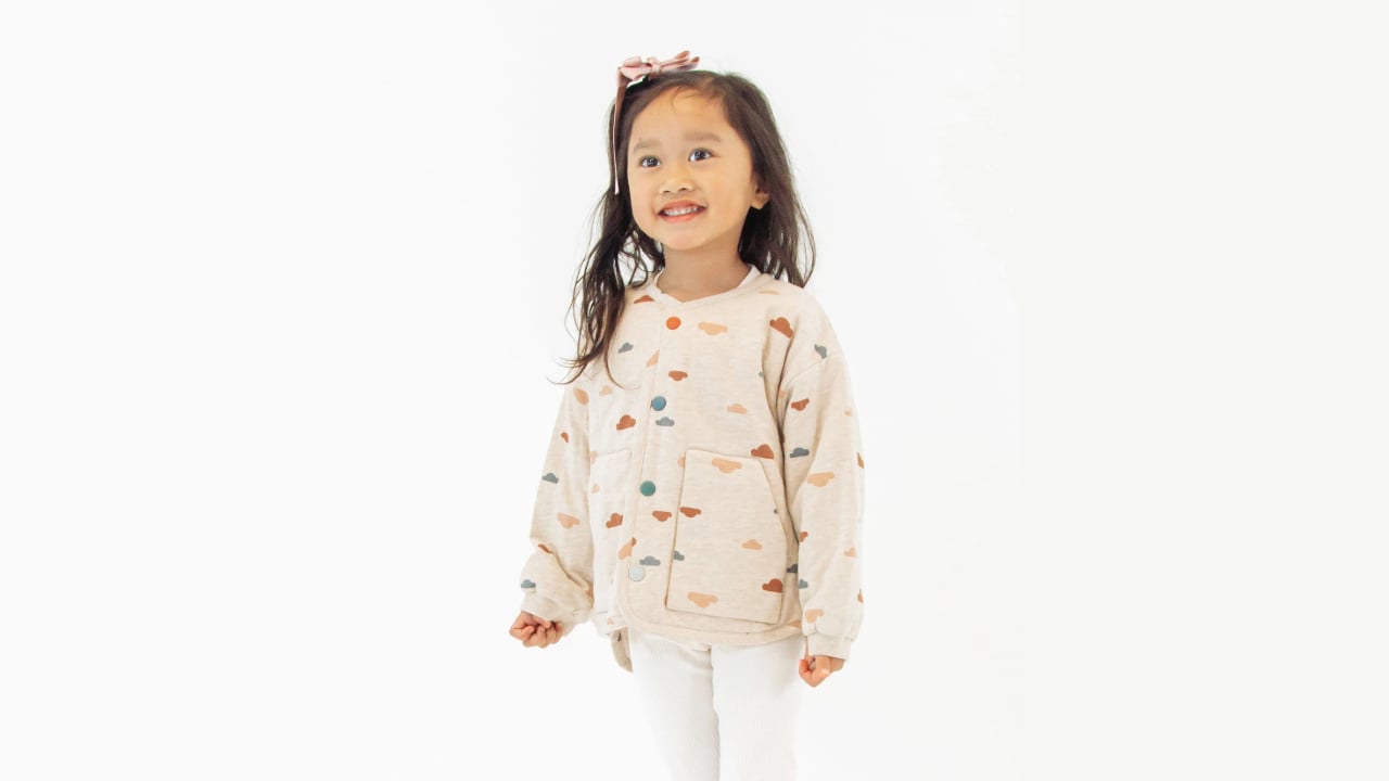 Child models gender-neutral outfit from clothing company Petite Revery