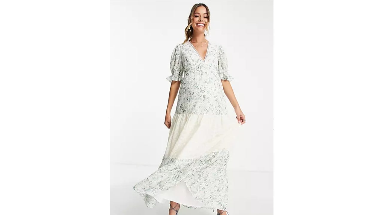 Pregnant woman wearing maternity broderie tiered midi tea dress in mixed ditsy print from Asos