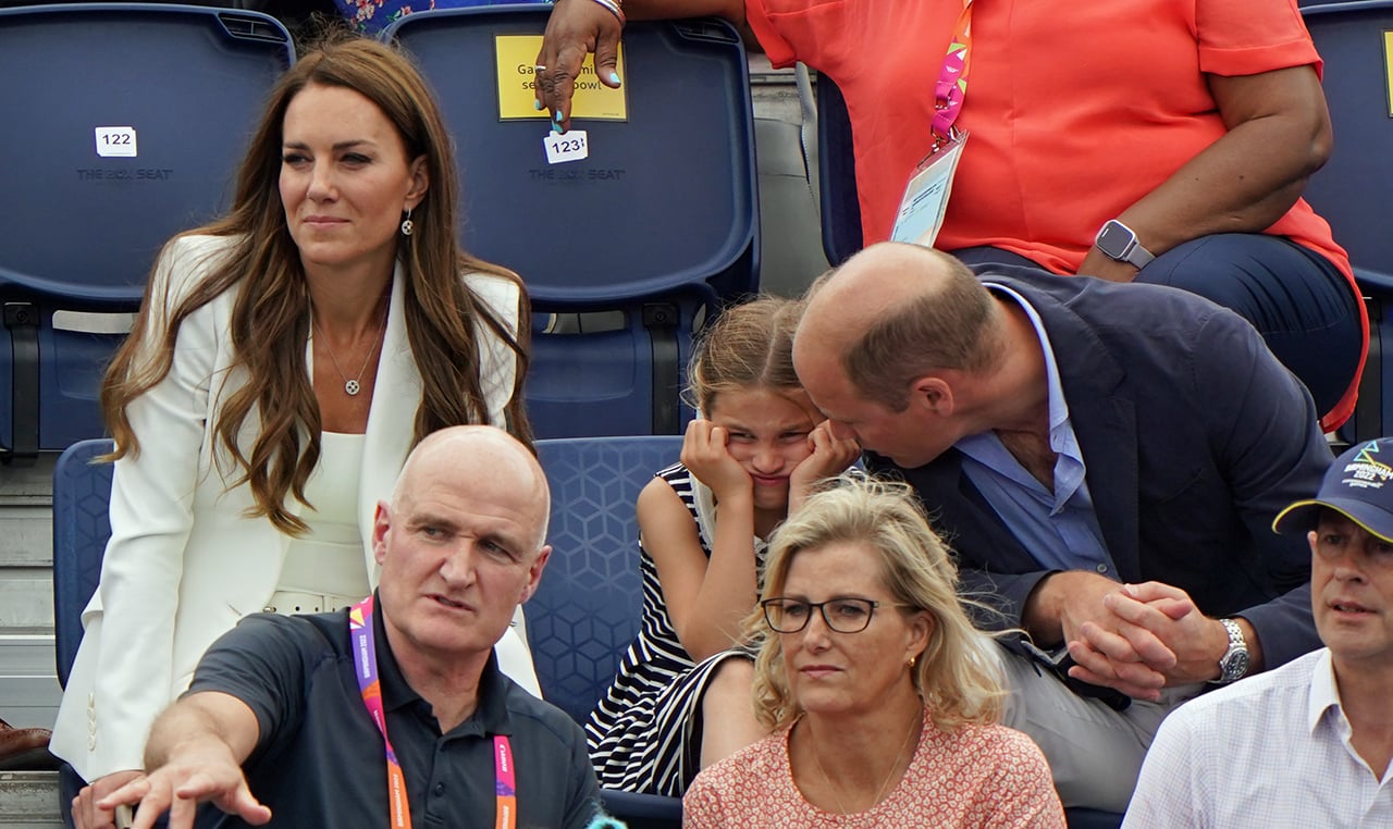 Princess Charlotte has her face in her hands looking bored while with her parents Prince William and Kate Middleton in the stands at the Commonwealth Games.